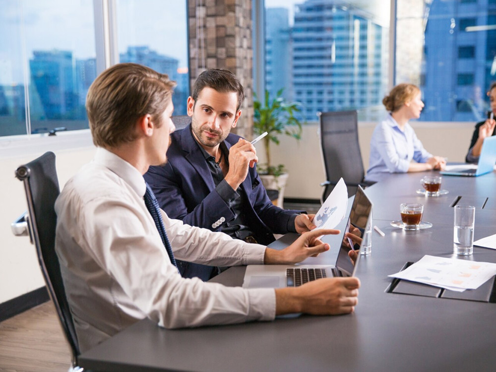 Professional advisors collaborating in a modern office meeting